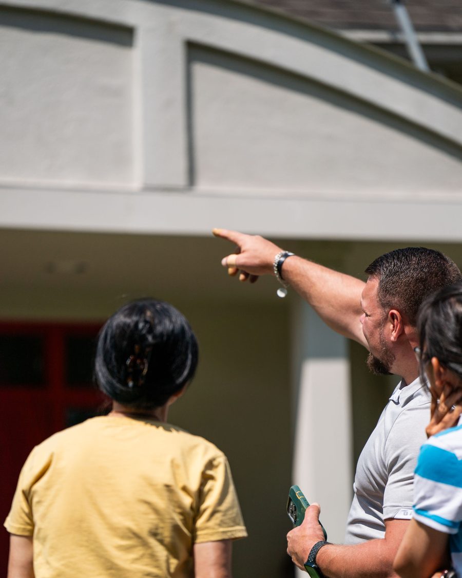 Travis walking a homeowner through what he found on their roof